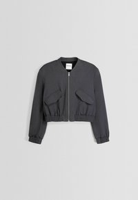Střižená šedá bomber bunda s předním zipem, dvěma velkými klopovými kapsami a elastickými manžetami a lemem; vyrobena z hladkého materiálu.