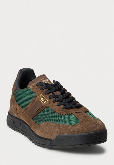 Men's sneaker featuring brown suede and green mesh panels, black laces, rubber sole, and gold logo accents.