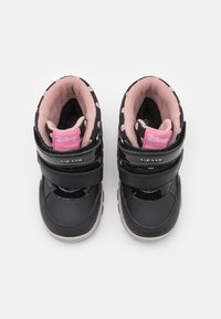 Černé boty pro batolata s dvěma suchými zipy, růžovým podšitím a puntíkovaným vzorem. Logo značky na pásku; gumová podešev s texturovanými akcenty.