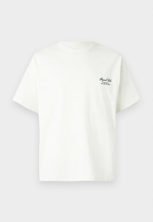 Hvid bomulds t-shirt med korte ærmer, rund halsudskæring og grøn tekstdetalje på venstre side, der viser brand- og lokationsinformation.