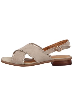 Beige flache Sandale aus Wildleder mit gekreuzten Riemen, dekorativen Nähten, verstellbarem Knöchelriemen und niedrigem Holzabsatz.