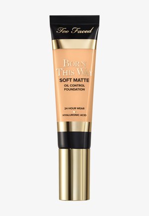 Tube van Too Faced Born This Way Soft Matte foundation met gouden dop, zwart en goud bovenstuk, gelabeld voor oliecontrole, 24 uur houdbaar, hyaluronzuur.