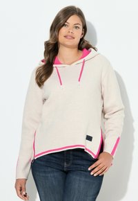 Pull en laine à capuche beige clair avec des accents et des détails en hem rose vif. Présente une fermeture éclair sur le côté, des manches longues et une coupe décontractée.