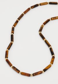 Brown and black striped beaded necklace featuring tubular beads, interspersed with gold-colored metallic accents. Smooth texture.