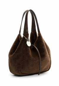 Brown faux fur handbag with a soft texture, two dark leather handles, and a silver charm attached. Rounded shape with no visible fastenings.