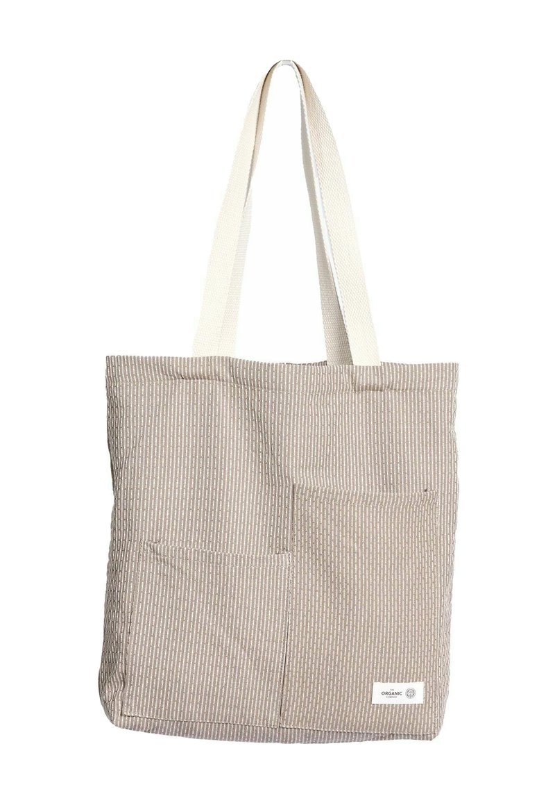 Bézs csíkos vászontáska két bézs színű szövetpánttal. Két első zsebbel és az alsó jobb sarokban címkével rendelkezik. Organikus pamutból készült.