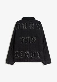 Čierna denimová bunda s golierom. Na chrbte je veľký biely vyšívaný nápis "BURY THE LIGHT" v tučnej typografii.