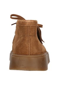 Brown suede ankle boot with a round toe, thick rubber sole, and lace-up design. Features soft texture and subtle stitching details.