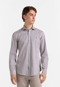 Gestreept overhemd met lange mouwen heeft verticale lijnen in blauw, oranje en wit. Het heeft een knoopsluiting aan de voorkant en een klassieke kraag.