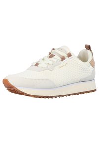 White sneaker with textured fabric upper, beige suede accents, brown lace loops, and a rubber outsole. Lightweight and sporty design.