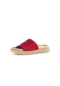 Red suede slide sandal with a wide strap featuring a decorative buckle and a beige rubber sole, designed for comfort and ease of wear.