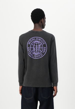 Long-sleeve dark gray T-shirt featuring a large round purple graphic with text on the back. Cotton material with a relaxed fit.