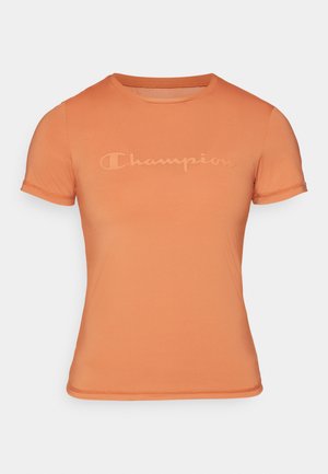 Korte ermet oransje t-skjorte laget av glatt stoff, med en subtilt preget "Champion" logo på forsiden og rund halsdesign.