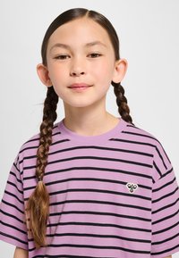 Lila gestreiftes T-Shirt mit schwarzen horizontalen Linien, aus Baumwollmaterial, legerer Schnitt, versehen mit einem kleinen gestickten Motiv auf der Brust.