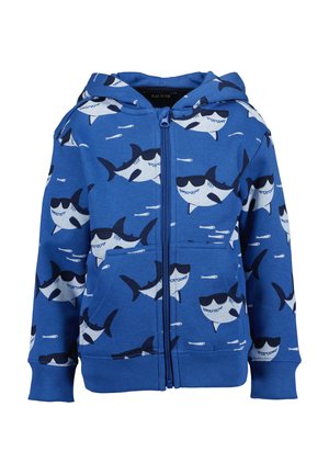 Sininen vetoketjullinen huppari, jossa on aurinkolasit päässään oleva hai-kuvio. Valmistettu pehmeästä kankaasta, siinä on resorit hihansuissa ja etutasku.
