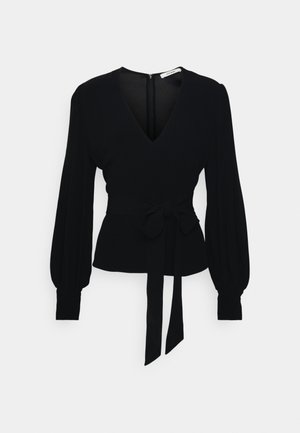 Black long-sleeve blouse with deep V-neck, puffed sleeves, fitted waist, and front tie detail on a plain light background.