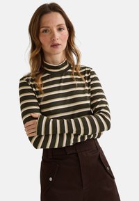 Haut à manches longues rayé avec des rayures horizontales vert foncé et beige, coupe ajustée, col haut et tissu doux et extensible.