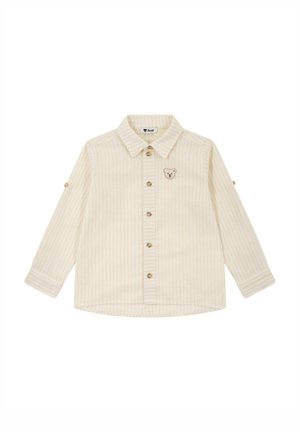Cream-colored long-sleeve shirt with vertical stripes, button fastening, and a small bear patch on the chest. Soft, textured fabric.