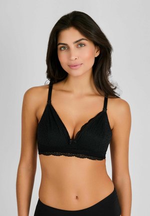 Sort blonde trekantet bralette med bølgede kanter, sløjfedetalje i midten, justerbare stropper og et tekstureret stofdesign.