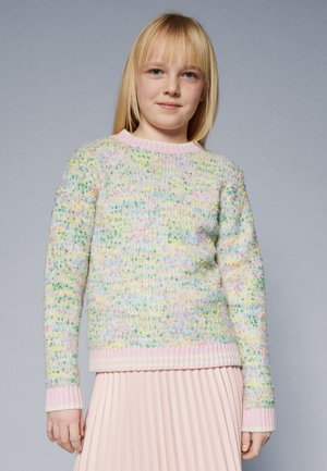 Multicolored knitted sweater with pastel dots, round neckline, and pink ribbed cuffs and hem. Worn over a pleated pink skirt.