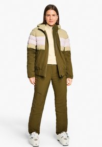 Olive green puffer jacket with light beige and lavender stripes, paired with matching olive pants. Features a zip closure and hood.