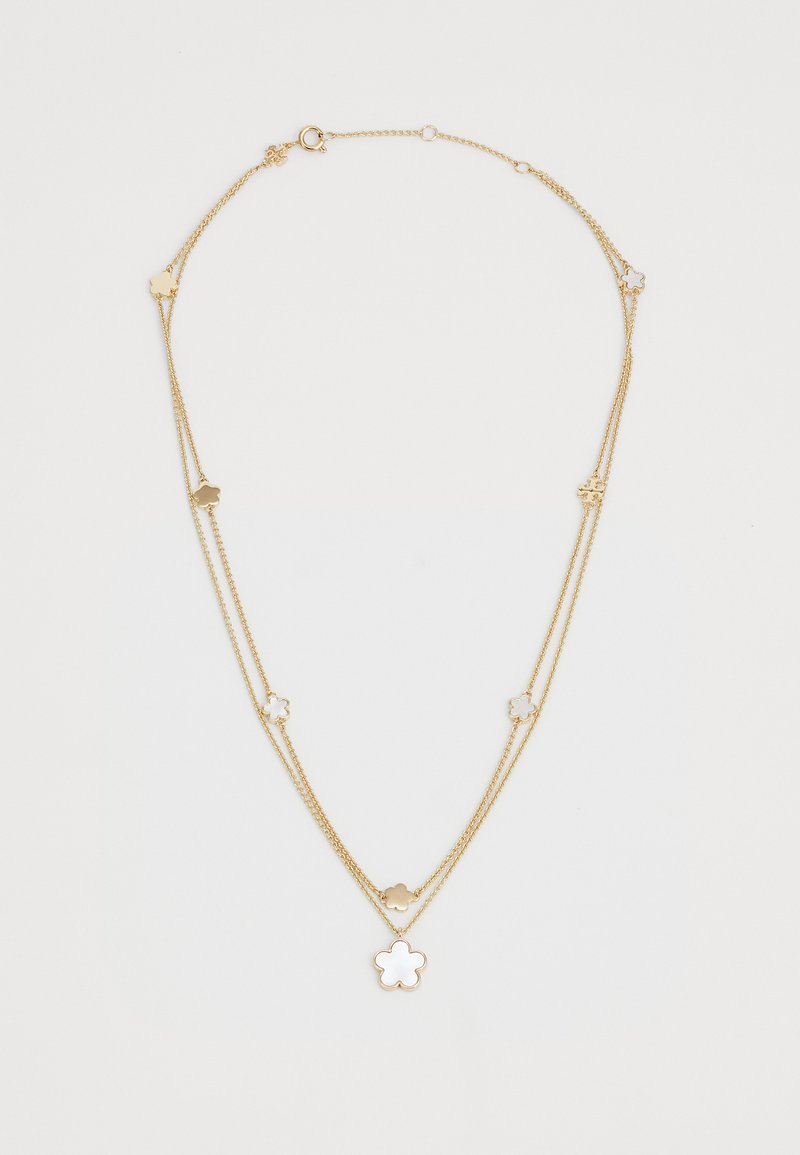 Auksu padengta grandinėlė su gėlių žavesiai, lygia tekstūra ir užsegimu su krabuku. Dvi grandinėlės ilgio suteikia galimybę reguliuoti stilių.