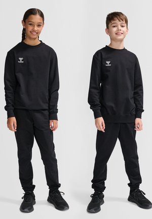 Set di felpa nera e pantaloni realizzato in tessuto morbido. Presenta un logo sul petto e polsini elastici sui pantaloni. Entrambi gli abbigliamenti sono semplici e coerenti.