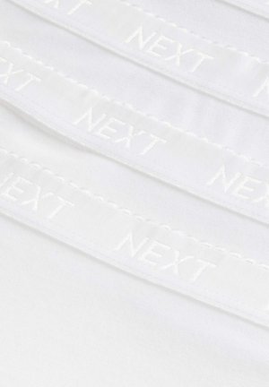 Tissu blanc avec des bandes élastiques brodées visibles affichant le mot "NEXT" en blanc, présentant un bord en scallop et une texture douce.