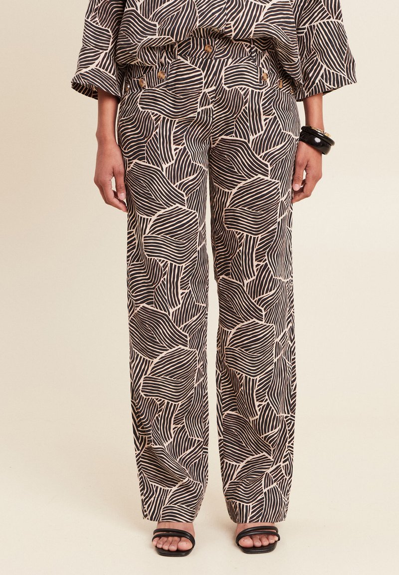Wijde broek met een zwart en crèmekleurig golfpatroon, gemaakt van soepel stof, voorzien van zijzakken en een aansluitende tailleband.