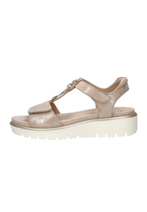 Beige open-toe sandal with adjustable straps, gold chain detail on top, and thick white textured sole for added height and comfort.