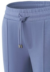 Light blue joggers with a smooth texture, elastic waistband, adjustable drawstring, and metallic accents on the drawstring ends.