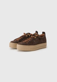 Brown suede shoes with a thick tan rubber sole, featuring brown laces and gold-tone hardware. Rounded shape, minimal design elements.