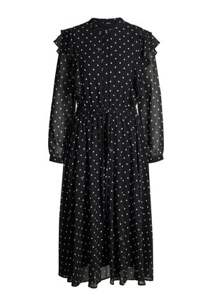 Zwarte polkadotjurk met een knoopsluiting aan de voorkant, gerimpelde schouders, lange mouwen, een ingezette taille en een vloeiende rok van lichtgewicht stof.