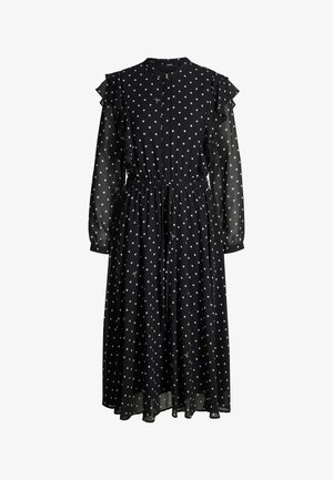 Robe noire à pois avec un devant boutonné, des épaules à volants, des manches longues, une taille froncée et une jupe fluide en tissu léger.