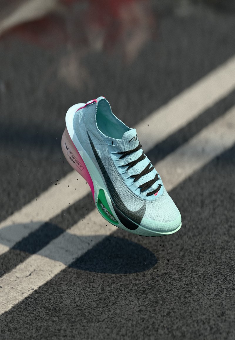 Light blue running shoe with a textured upper, black laces, and a pink and green sole. Features a sleek design and visible branding on the side.