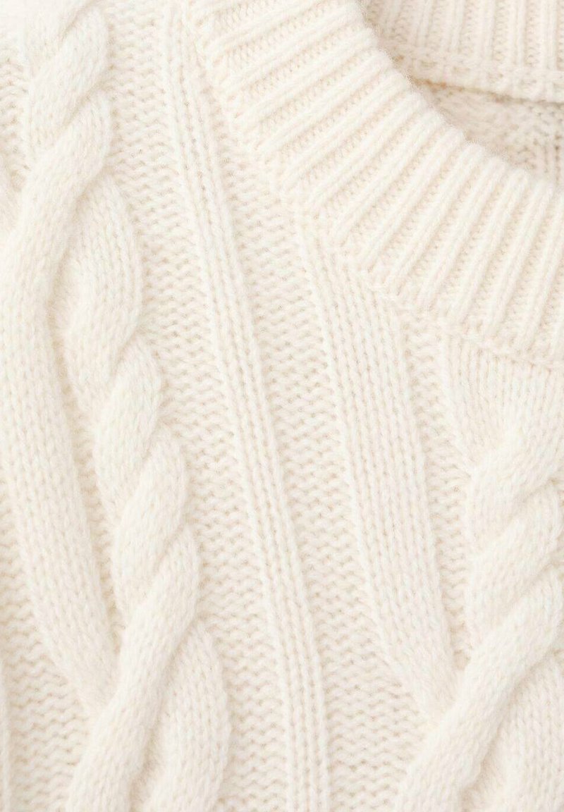 Chunky white knit sweater with cable pattern, featuring ribbed neckline and textured body for warmth and comfort.