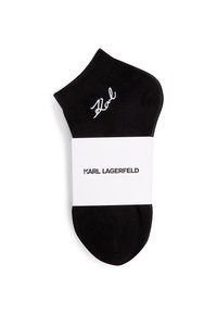 Melna potīte ar baltu "Karl" izšuvumu pie manšetes un baltu joslu ar uzrakstu "Karl Lagerfeld" vidū.