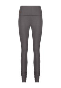 Grå leggings gjorda av mjukt, stretchigt tyg. Hög midja med samlad detalj vid mudden. Slät yta, åtsittande design.