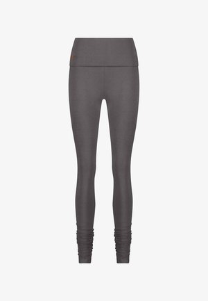 Grijze leggings van een zachte, rekbare stof. Hoge tailleband met gathered details bij de enkels. Glad textuur, aansluitend ontwerp.