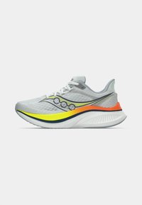 Gray athletic shoe with a textured mesh upper and a cushioned sole. Features yellow and orange accents along the sides and a white outsole.