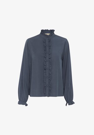 Blouse bleu marine avec un devant à volants, col montant et fermetures à boutons. Comprend des manches longues avec des poignets élastiques et un tissu lisse et léger.