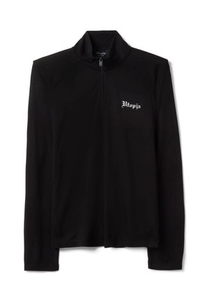 Chemise noire à manches longues avec fermeture éclair quart de zip et texte blanc « Utopia » sur la poitrine gauche, taille moyenne, fond uni.