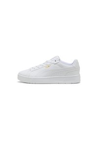 White athletic shoes featuring a smooth synthetic upper, round toe, lace-up design, padded collar, and a textured rubber sole. Gold logo detail.