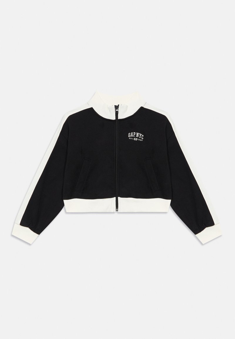 Svart zip-up jakke med hvite detaljer, høy krage og logo på brystet. Laget av myk stoff, med to frontlommer og ribbestrikkede mansjetter.