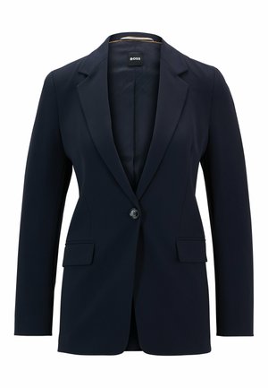 Blazer navy en tissu lisse, avec fermeture à un bouton, revers crantés et deux poches avant. Design simple et ajusté.
