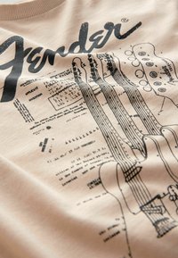 Fender grafisk sweatshirt i beige med sort linjekunst af guitar komponenter og patentdetaljer. Blødt stof med ribbet halsudskæring.