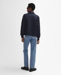 Navy quilted jacket with a collar, long sleeves, and ribbed cuffs, paired with light blue straight-leg jeans and black shoes.