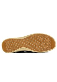 Semelle en caoutchouc avec une texture à motif antidérapant ; couleur beige avec des accents noirs. Légèreté et conçue pour l'adhérence et le confort.