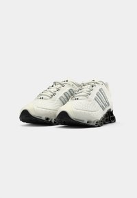 Pair of white athletic shoes with black soles and gray side stripes, positioned side by side on a plain white background.
