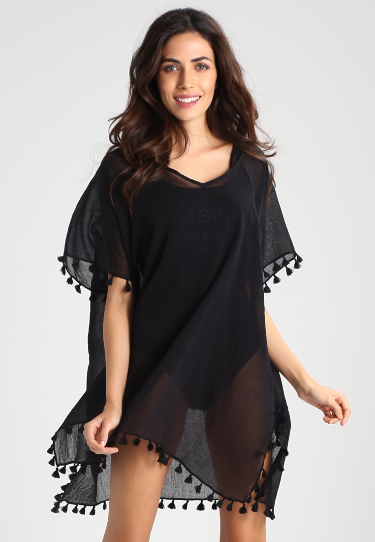 Black poncho-style cover-up made of lightweight, sheer fabric. Features tassel accents along the hem and a V-neck design.